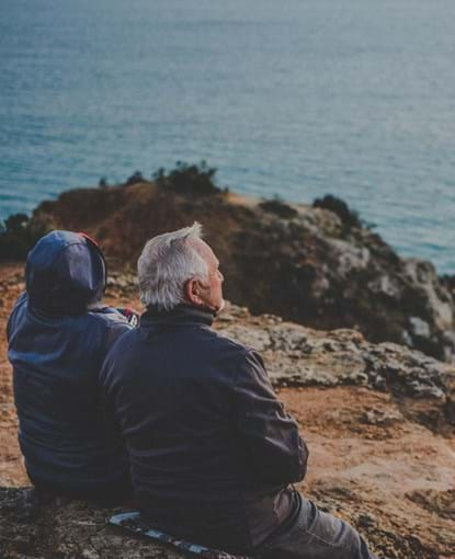 Couple facing the sea