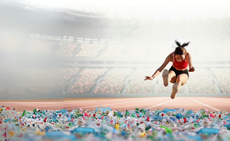 Long jumper jumping into pile of plastic