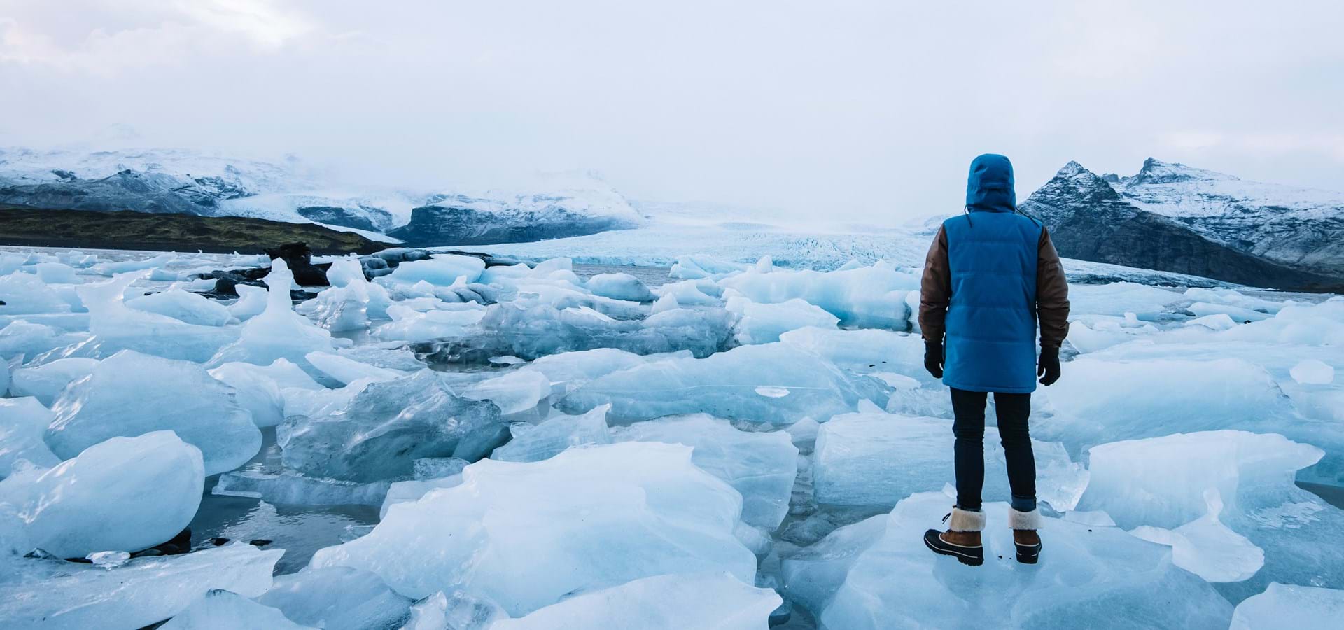 Man standing in front of icy sea