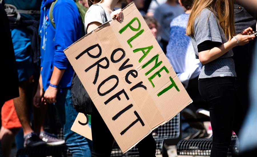 Climate protest with sign reading: people over profit