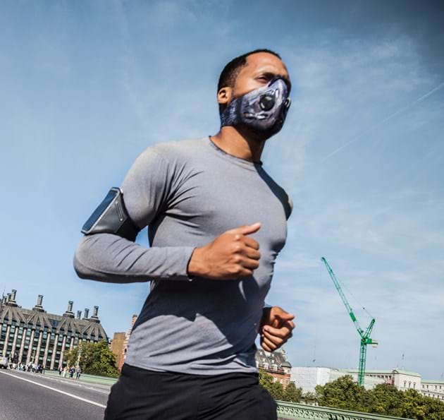 Man running across Westminster Bridge with mask on
